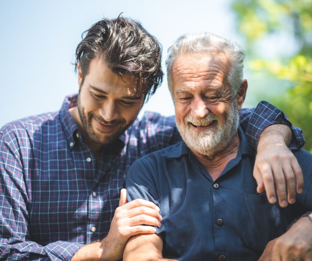 caucasian senior father and adult son are hugging together at home, generation family are happy with people love, male mature, old person man, elderly grandfather smiling living at the house