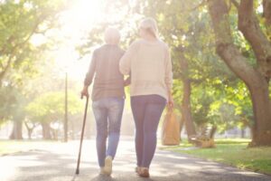 adult children walking with parent on a sunset